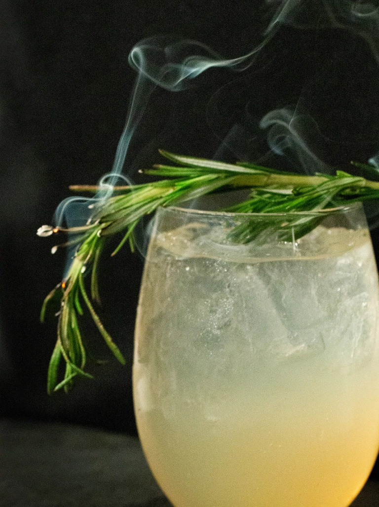 A craft cocktail smoked with rosemary